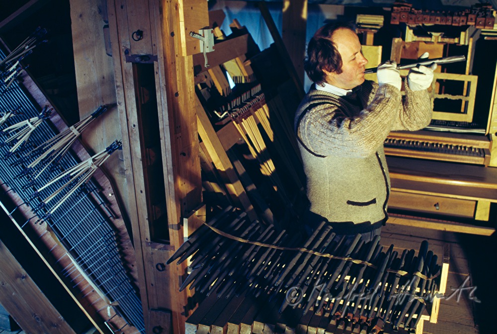 organ builder with organ pipes in the church