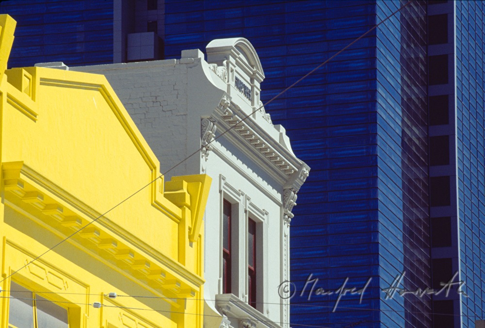 yellow appartement building and skyscraper