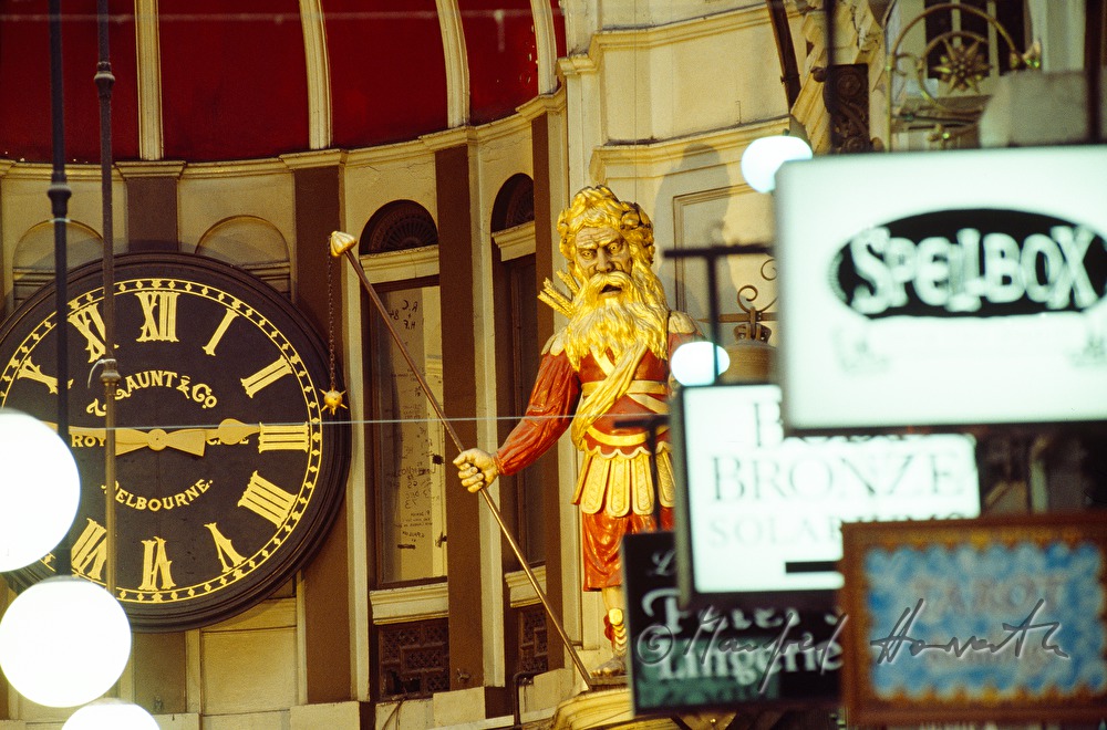 shop signs, watch and statue of mall