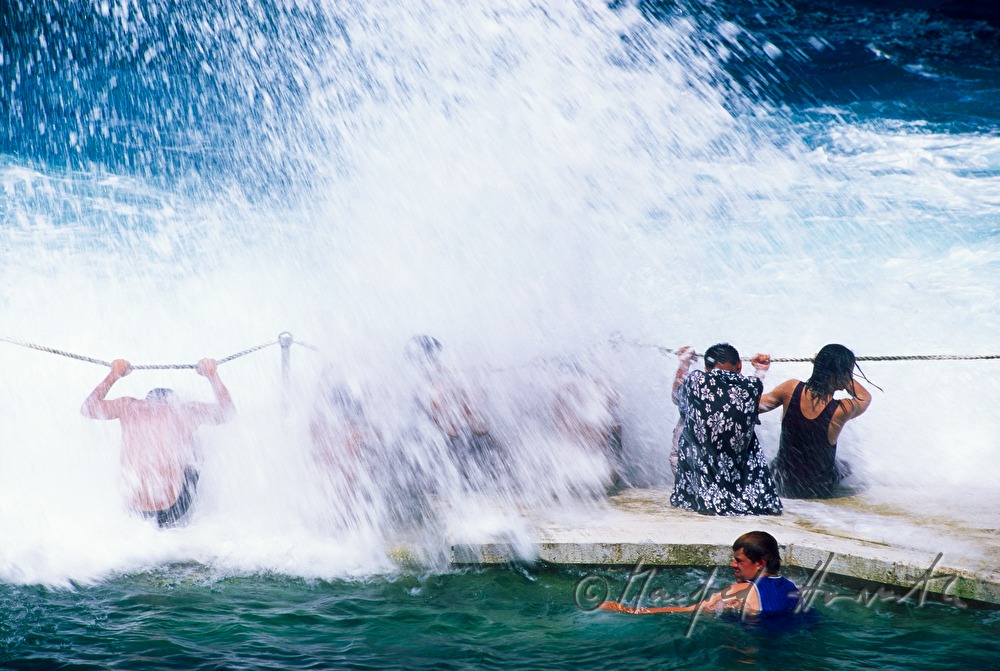 swimmer and spectators of the surfing