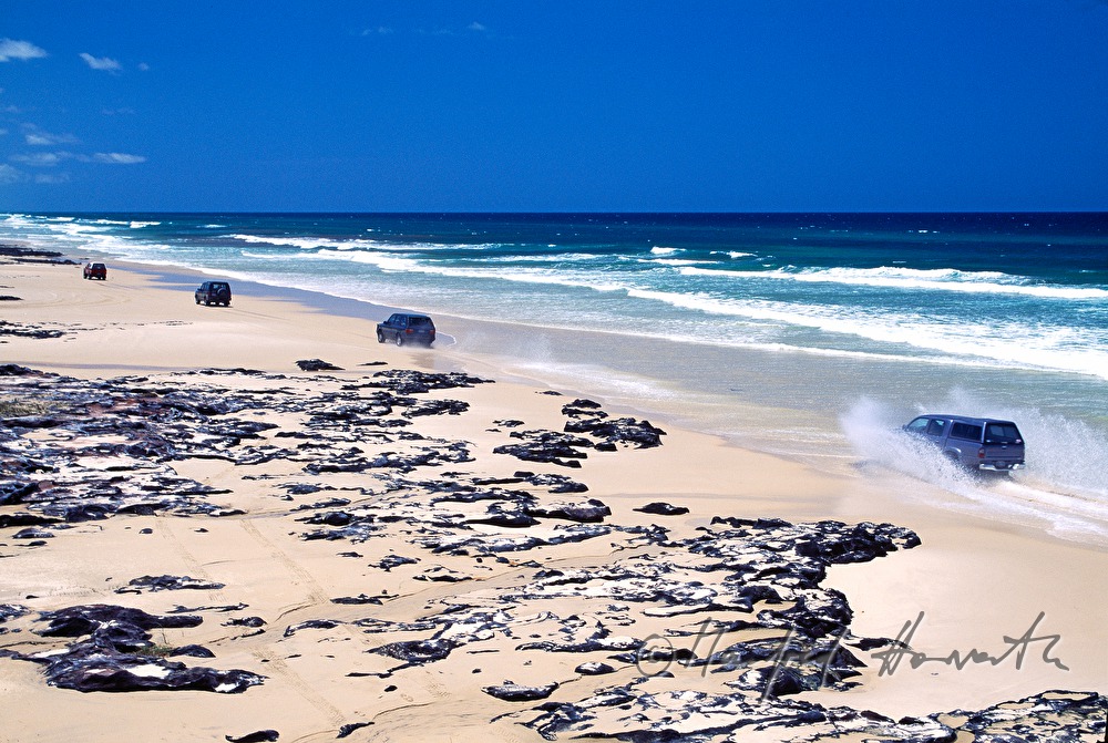 off-road vehicles drive on the beach