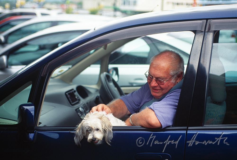 man with dog in a car