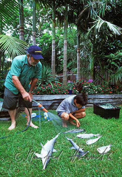 father and son with the catch in the garden