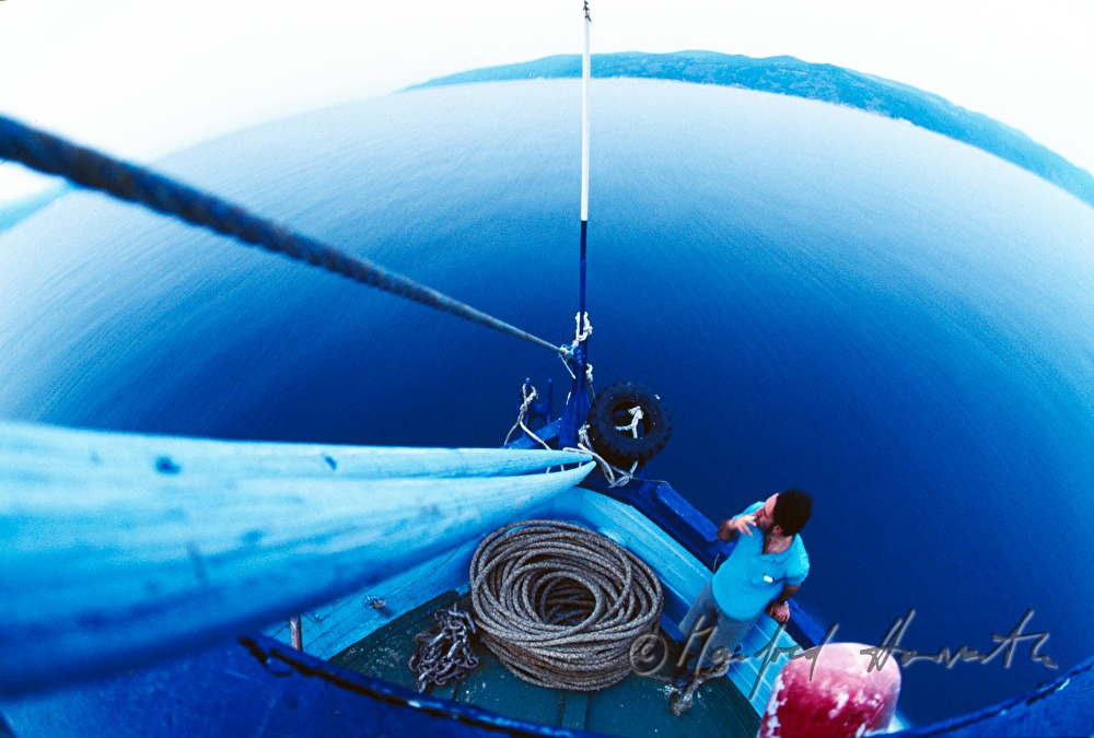 fisherman smokes on the bow of the ship
