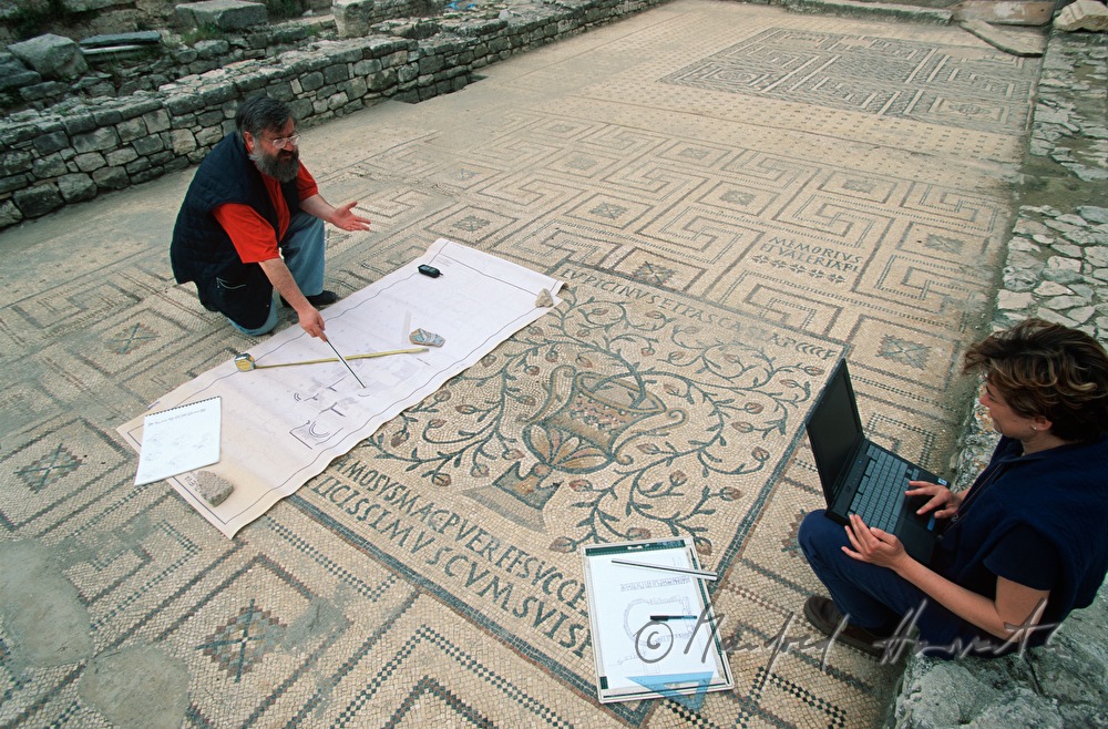 archaeologists with floor mosaic from the Roman Age