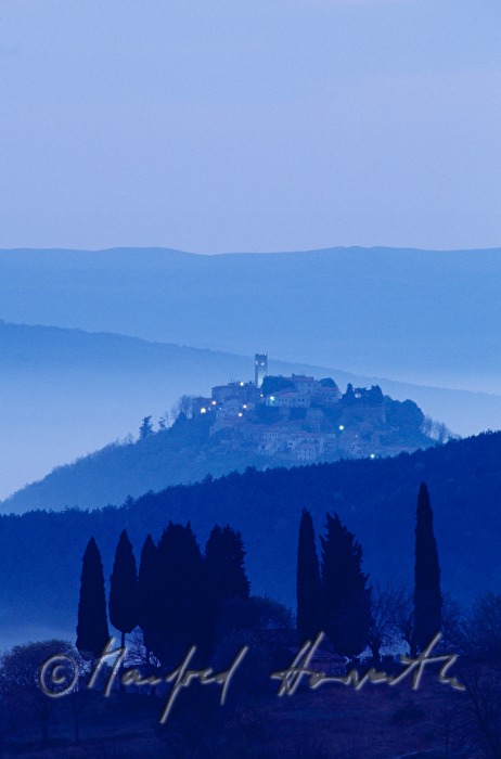 town and cypresses in the valley
