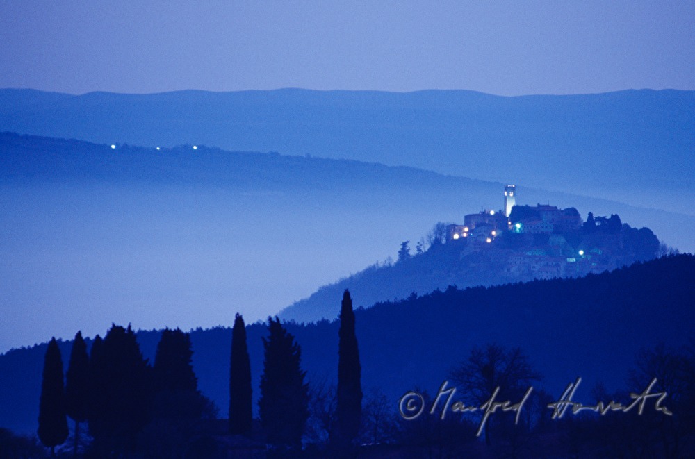 town and cypresses in the valley