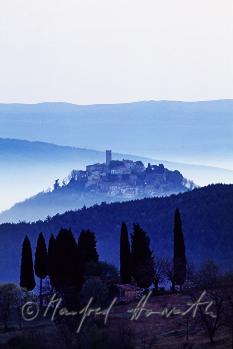 town and cypresses in the valley