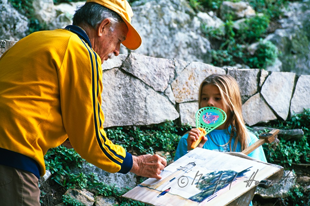 painter features a lighthouse as a girl watches him
