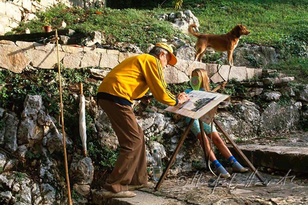 painter features a lighthouse as a girl watches him