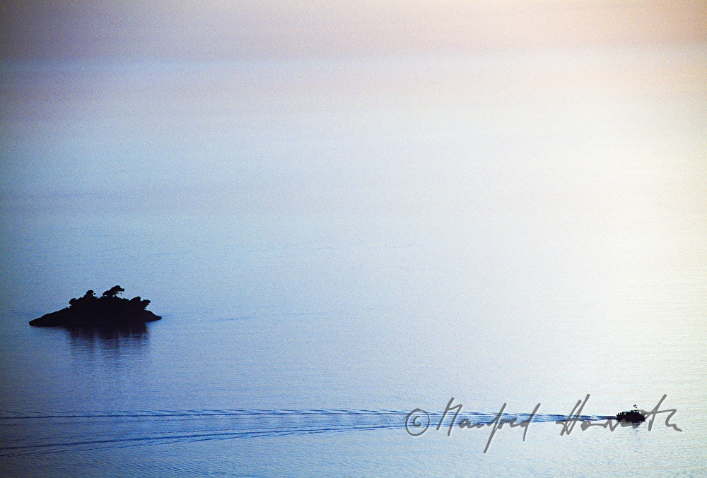boat passing an islet