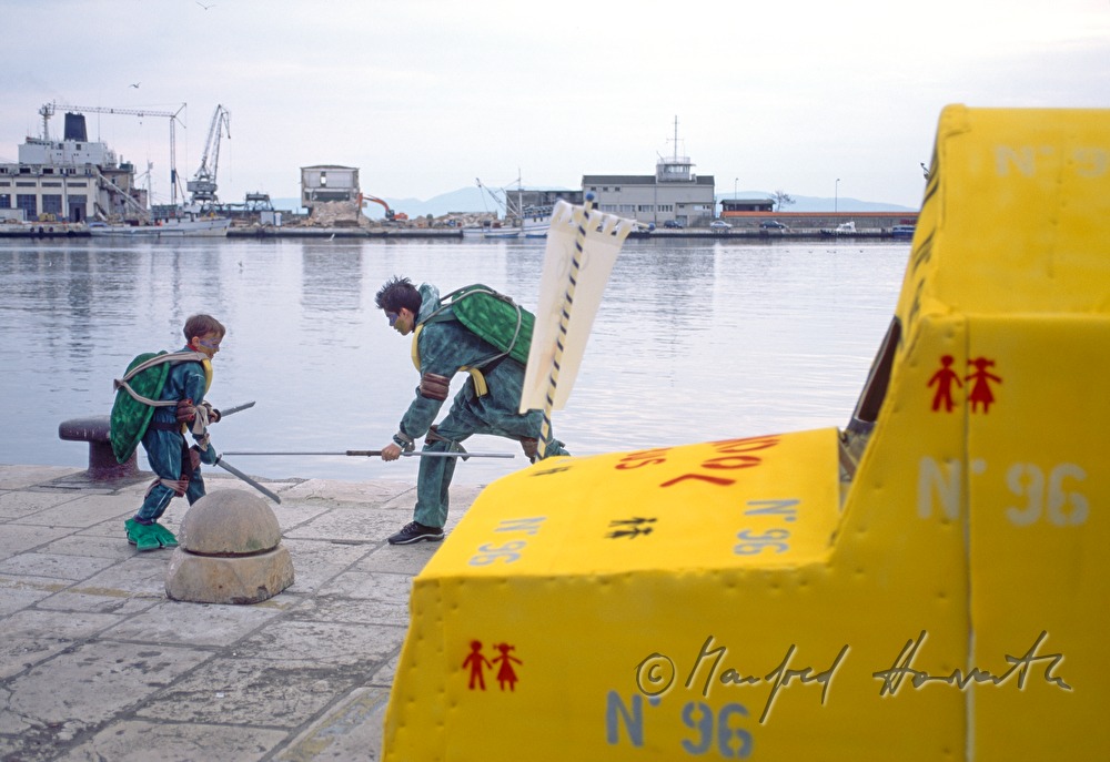 Boys dressed as Ninjaturtles play at the harbour.