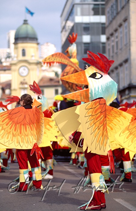 Carnival group dressed up as chicken in front of the city tower.