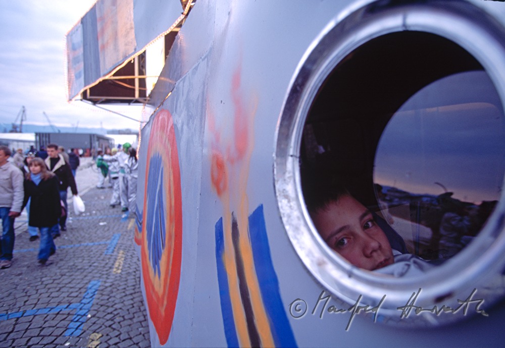 Boy looks out a rocket.