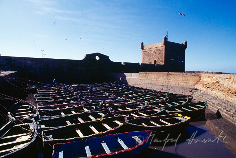 boats and harbour wall with citadel