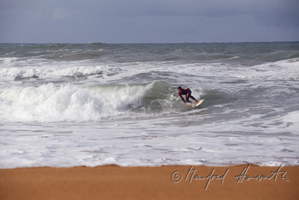surfer on the shore of the Atlantic Ocean