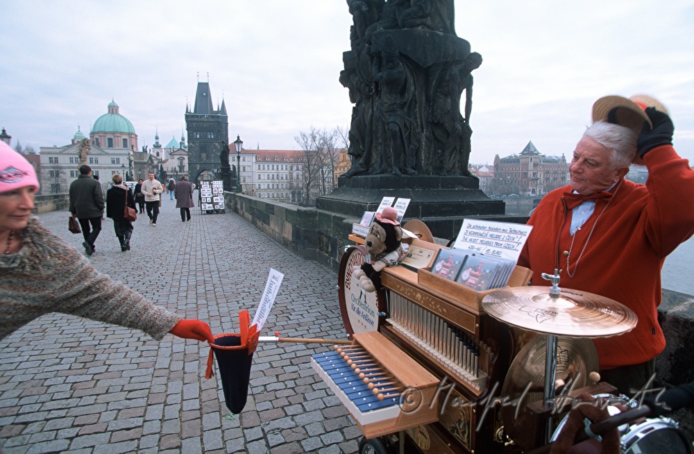 street musician plays Mozart on barrel organ