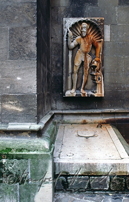 tomb on the outside wall of the church