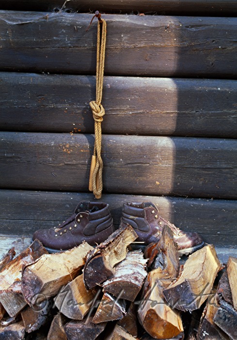 tramping boots on a wood pile