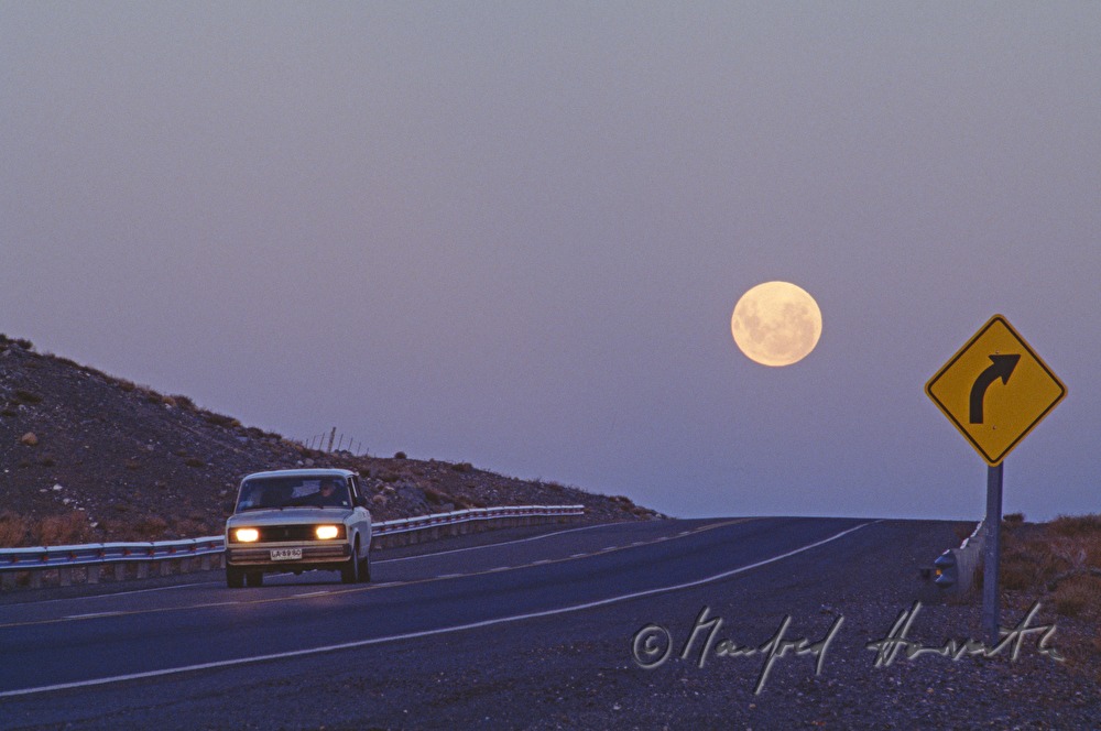 Lada on the road and full moon