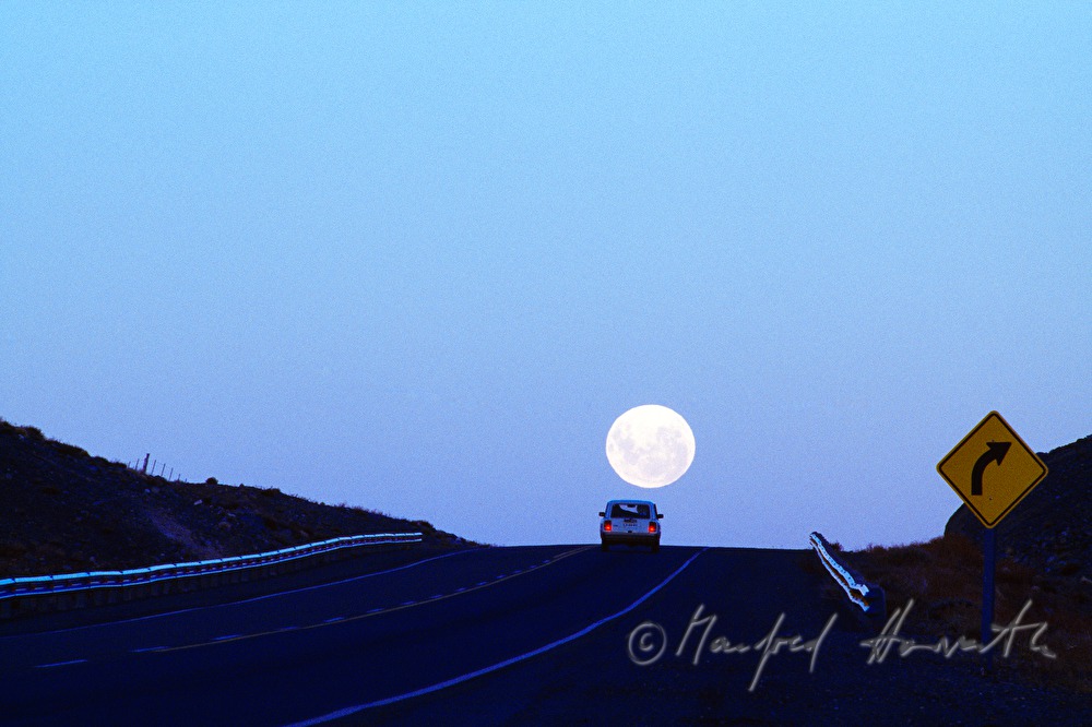 Lada on the road and full moon