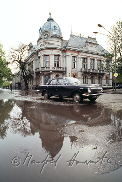 car passing a puddle after the rain