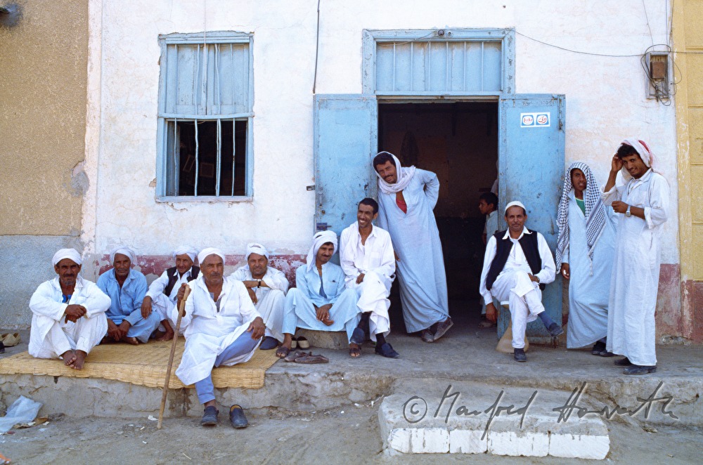 group of men in front of a house
