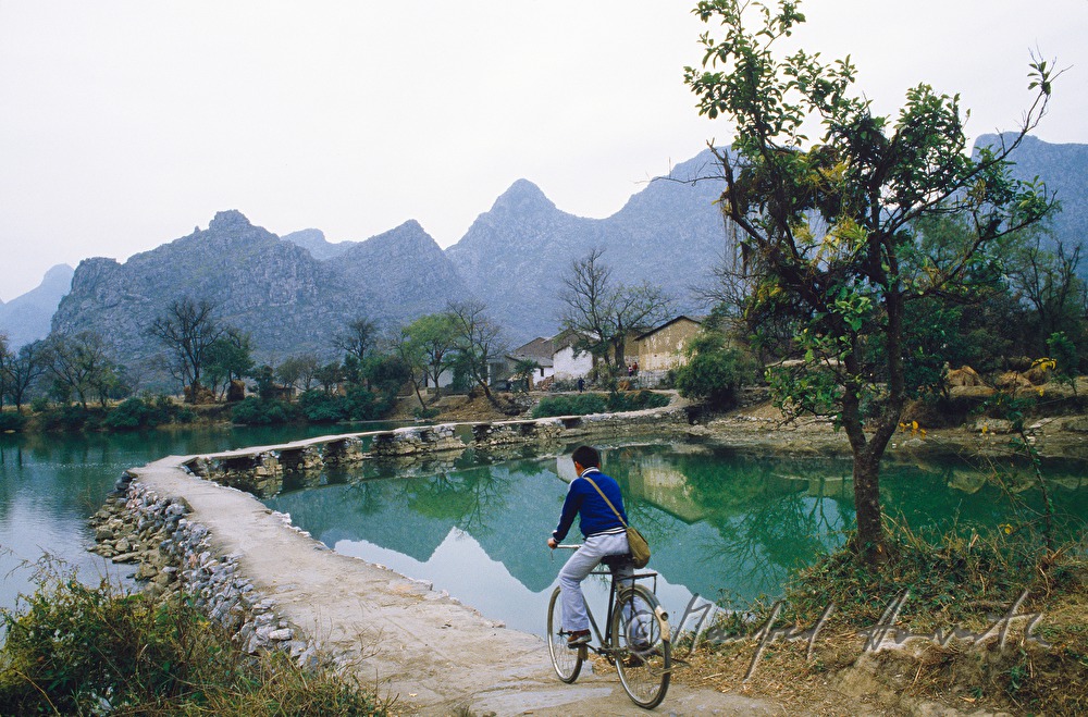 cyclist on the way to a farm house