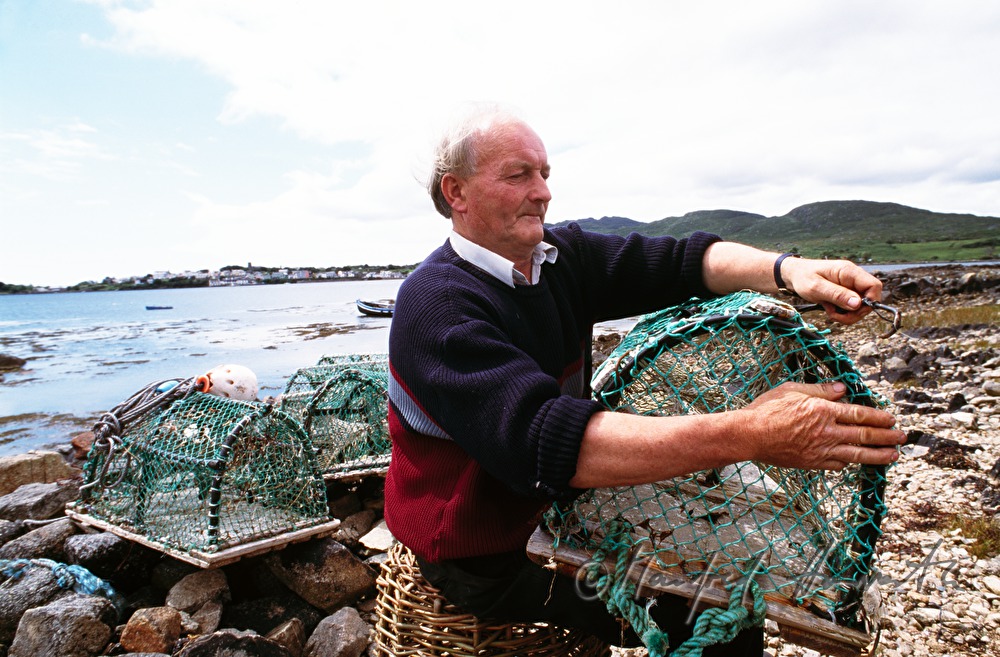 lobster fisherman with bow net on the shore