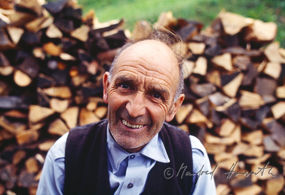 farmer near a wood pile