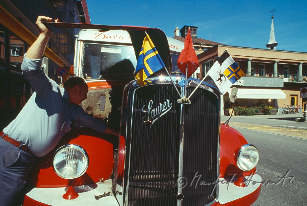 driver of an oldtimer bus checking the motor