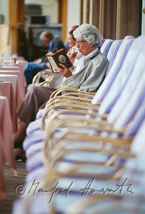spa guest reading a book on the terrace