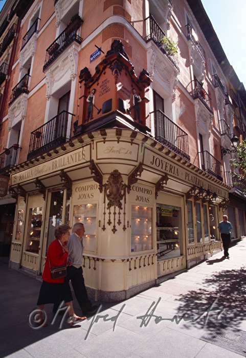 pedestrians pass a jeweler shop