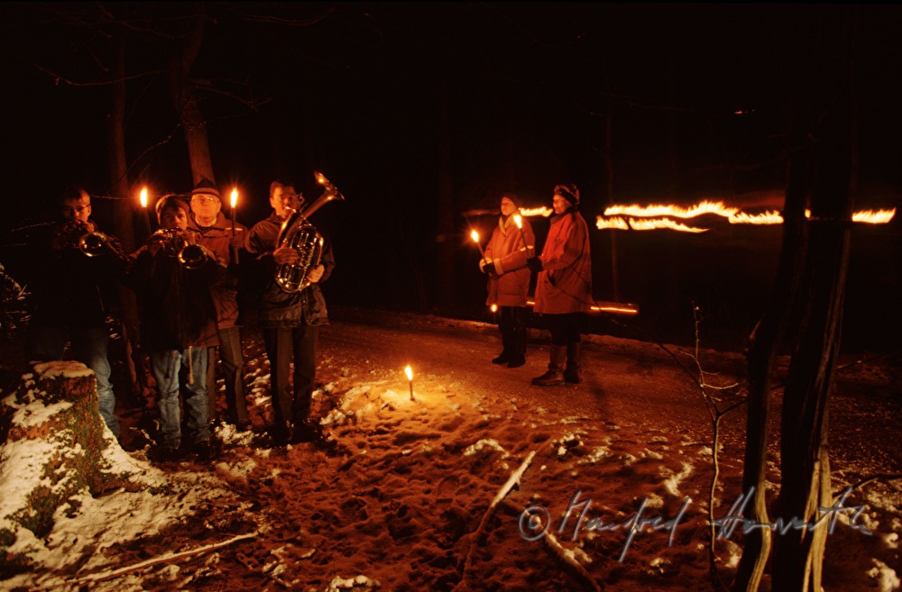 horn players in the forest during a procession