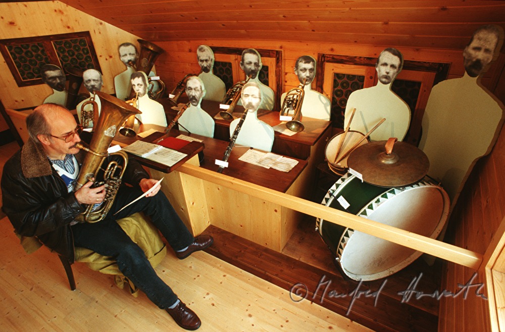 musician tests an instrument at the brass instrument museum