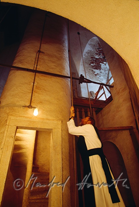 monk pulls the bells of monastery Zwettl