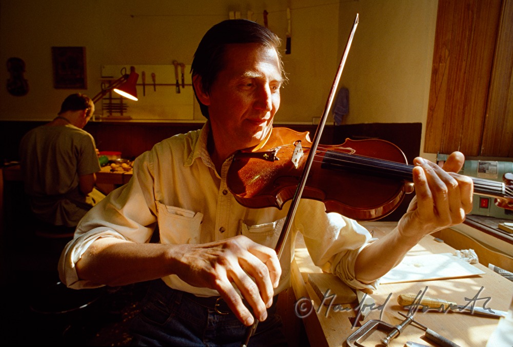 master craftsman Krillov tests a violin