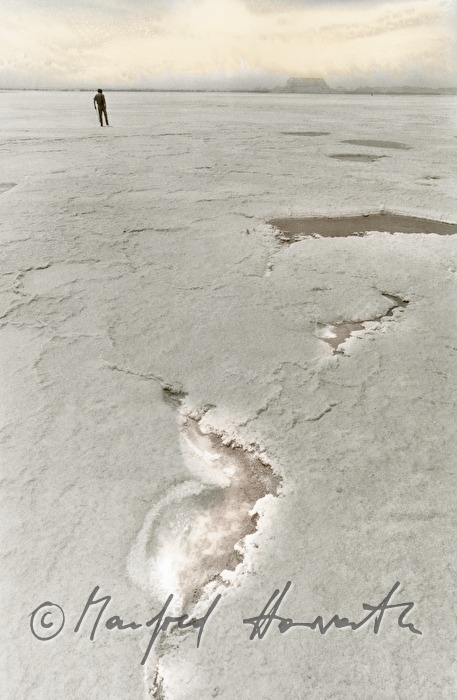 man crosses a salt lake