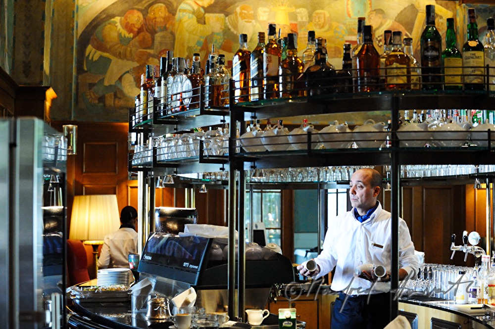 waiter in the bar preparing coffee