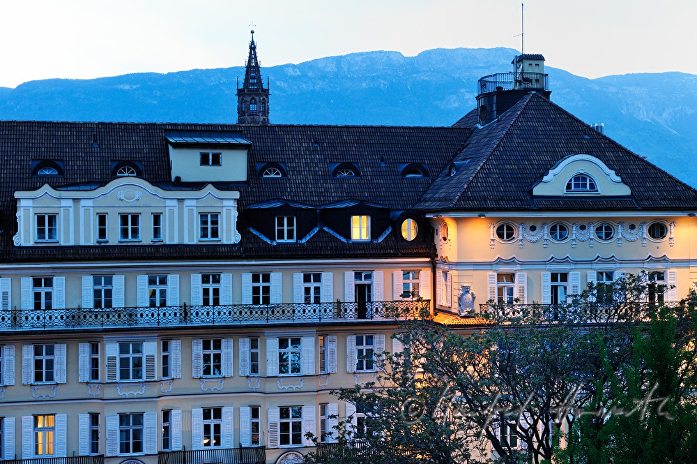 hotel in nightly illumination with Dolomite Alps