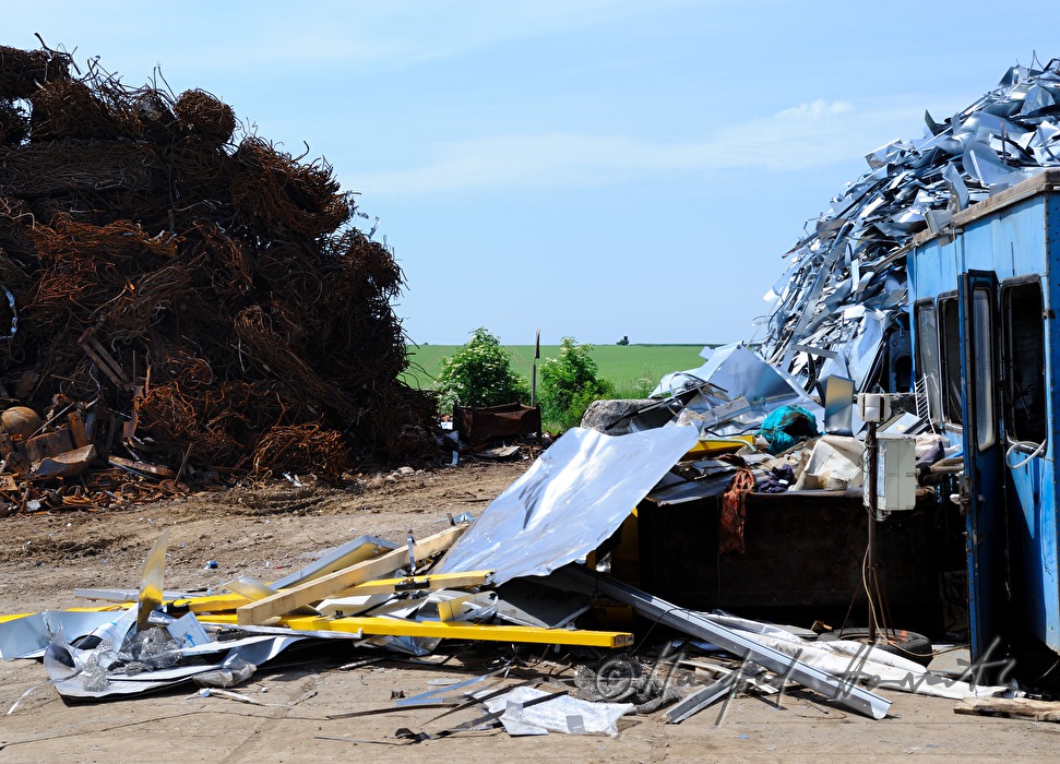 gripper loading metal scrap at a salvage yard