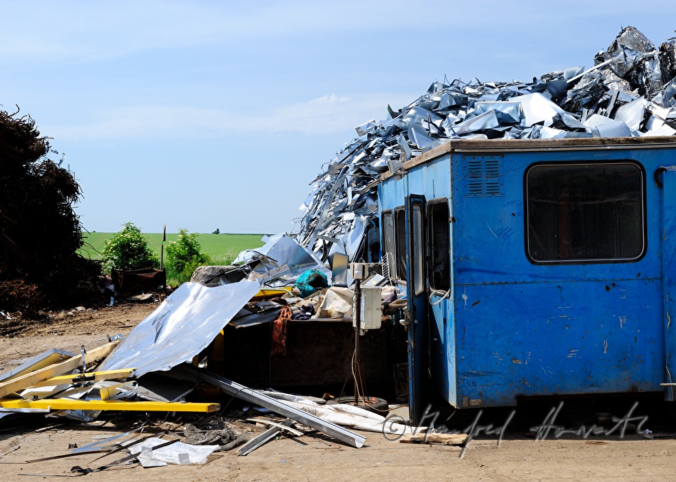 gripper loading metal scrap at a salvage yard