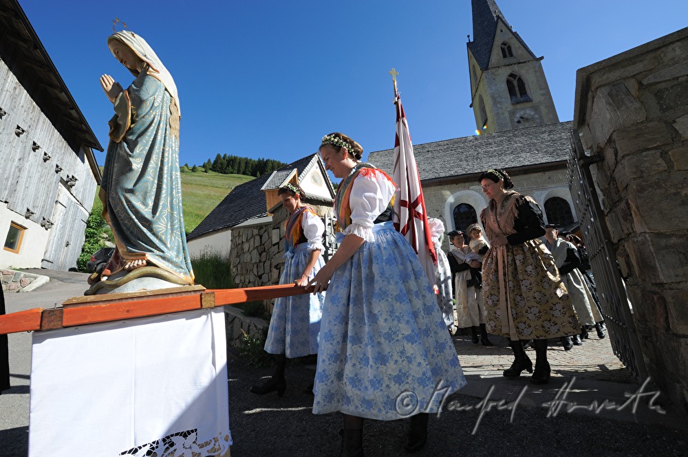 women carry a statue of Holy Mary