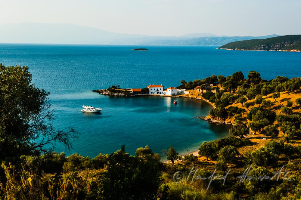 small bay with a luxury house and a yacht