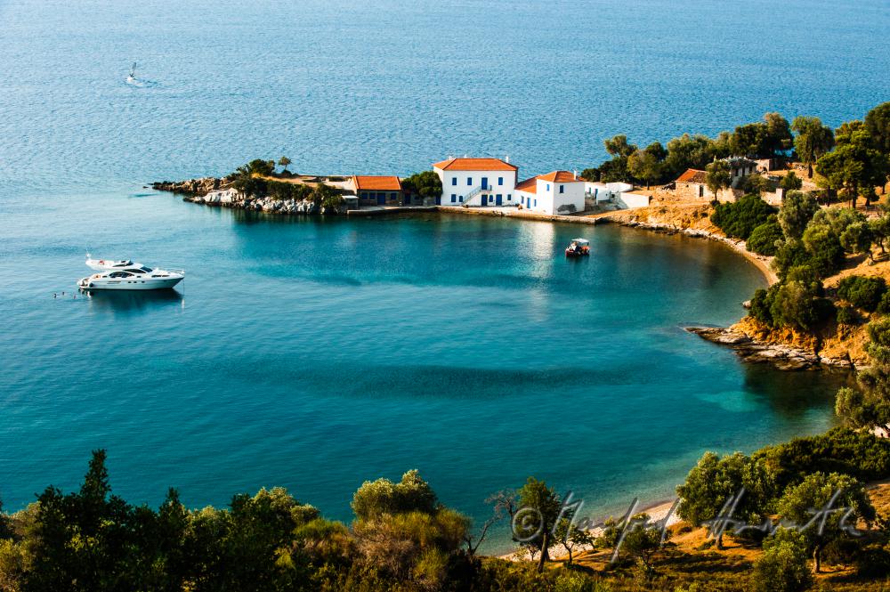 small bay with a luxury house and a yacht