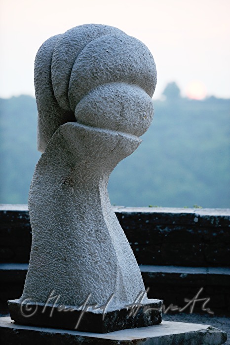 stone sculpture and sun