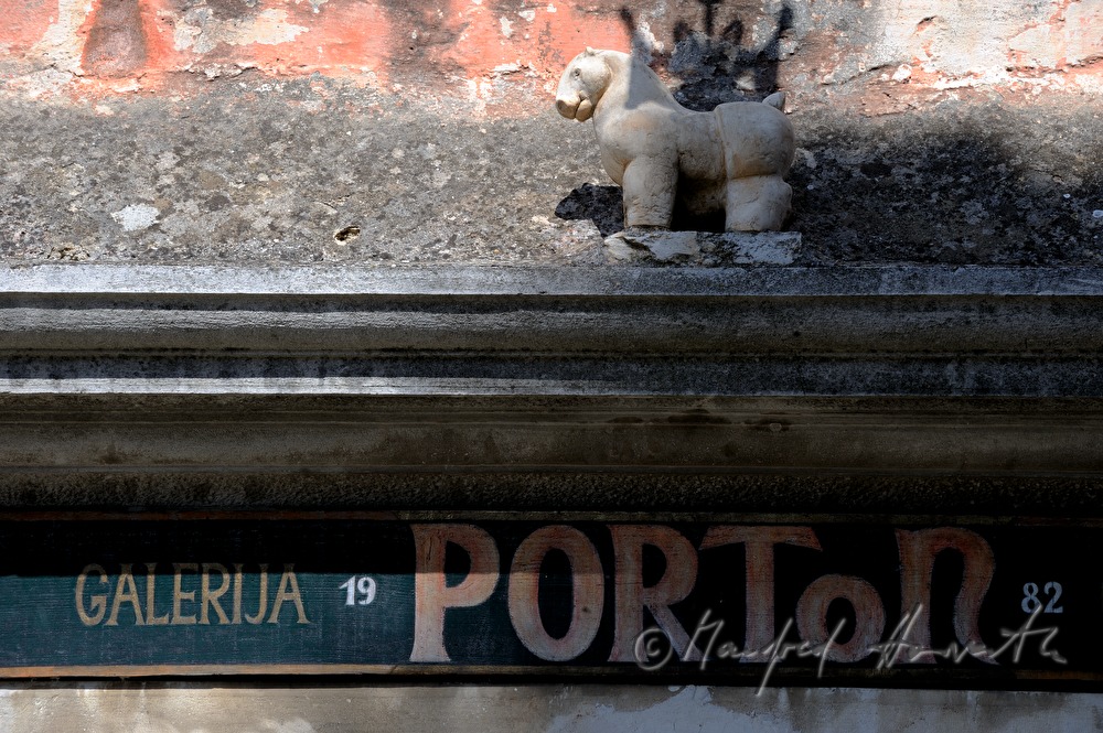 sign and Winged Horse on the cornice