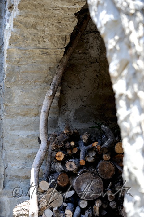 stacked fire wood at a house wall