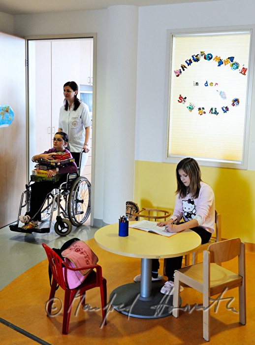 nurse moving child to the play room