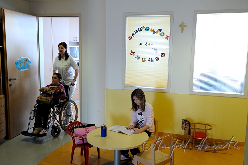 nurse moving child to the play room